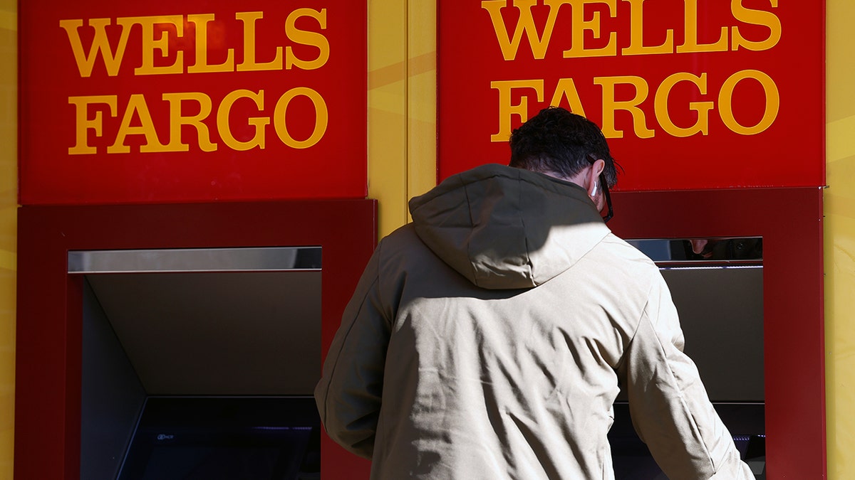 A man uses a Wells Fargo ATM.