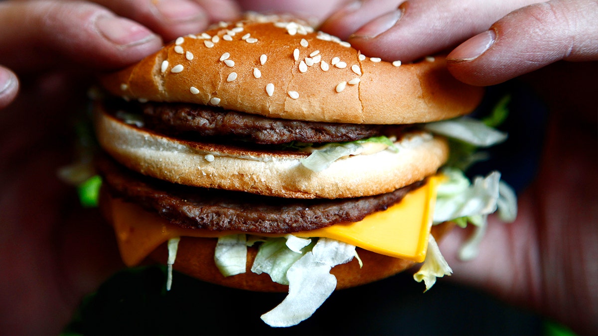 Big Arch burger with two beef patties, cheddar cheese, and crispy slivered onions on a bun