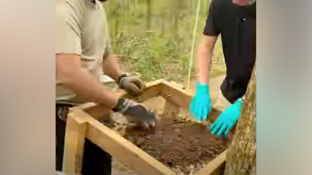 Los investigadores revisan el suelo en busca de más restos humanos cerca del arroyo