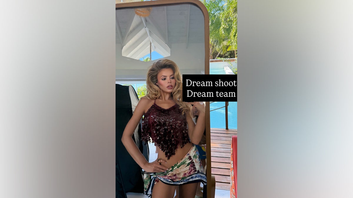 Brooks Nader takes a mirror selfie in a sequin top with a patterned skit.