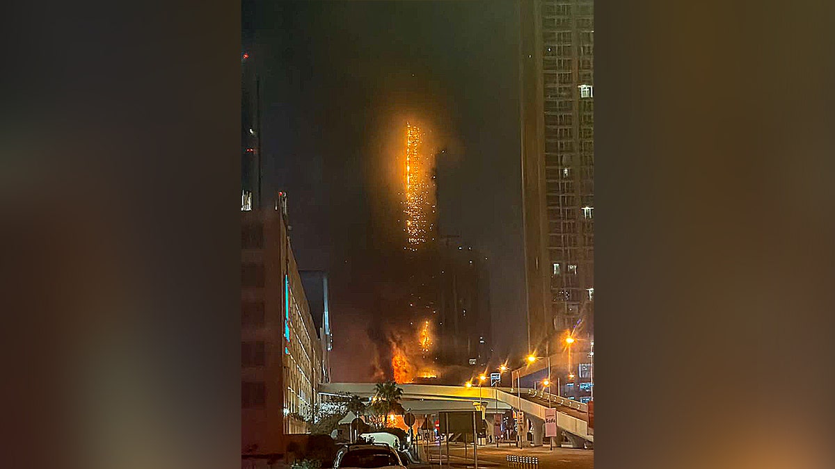 half a high-rise building on fire
