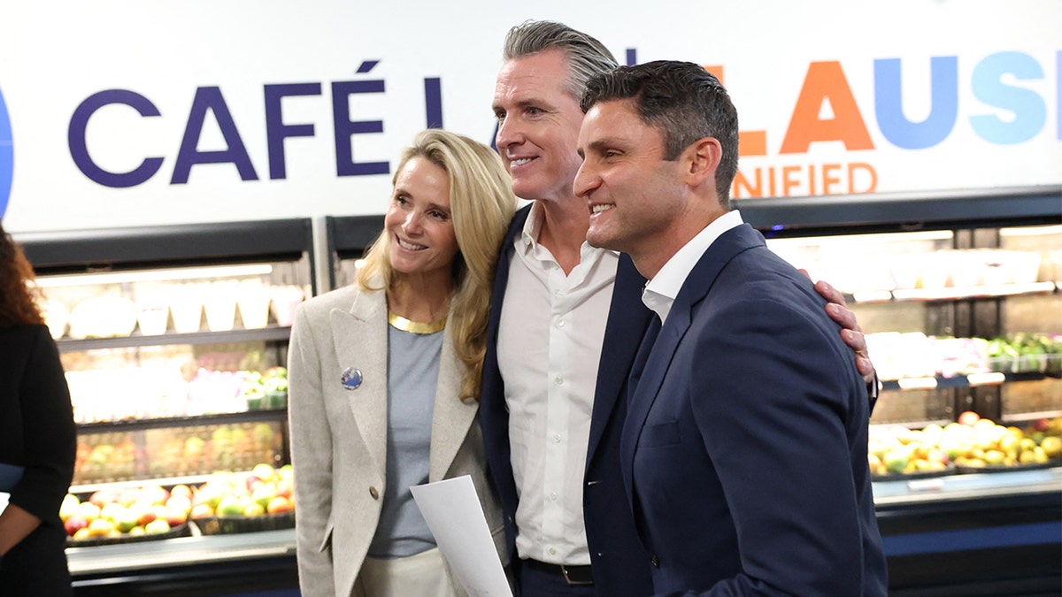 Gabriel standing with Gavin Newsom