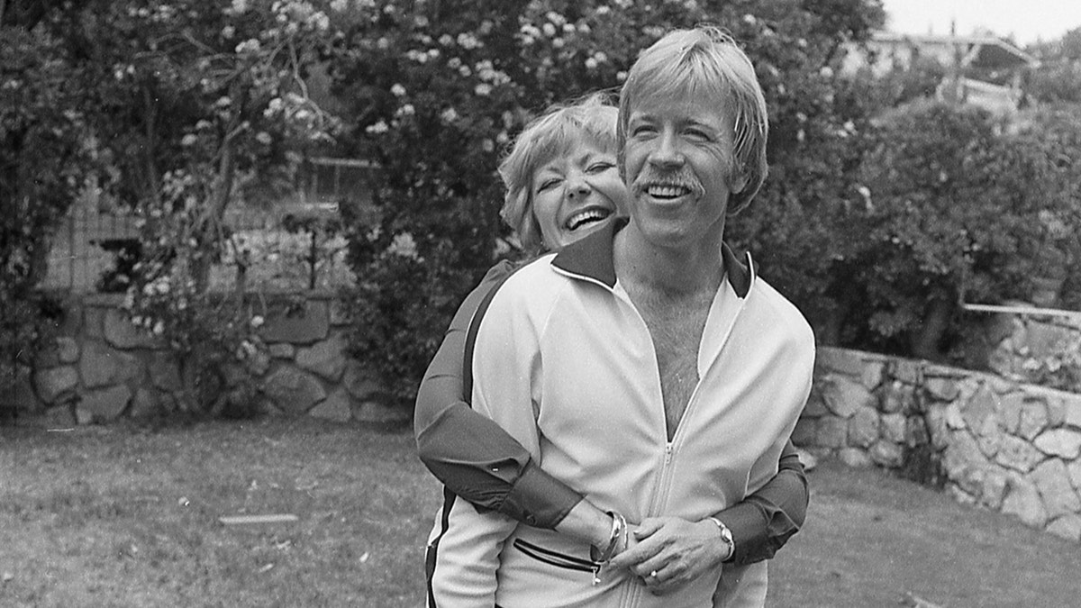 Chuck Norris being embraced by his wife Dianne at their California home.