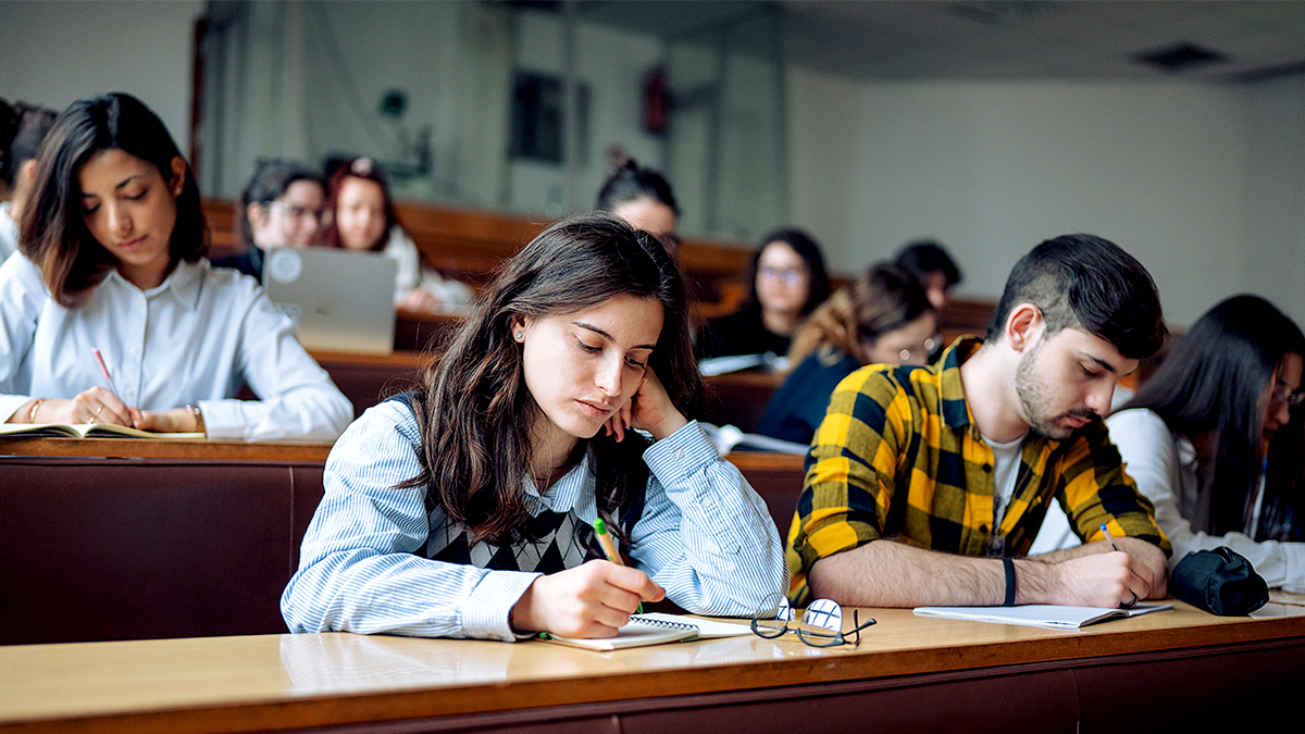 College students taking test in classroom stock image