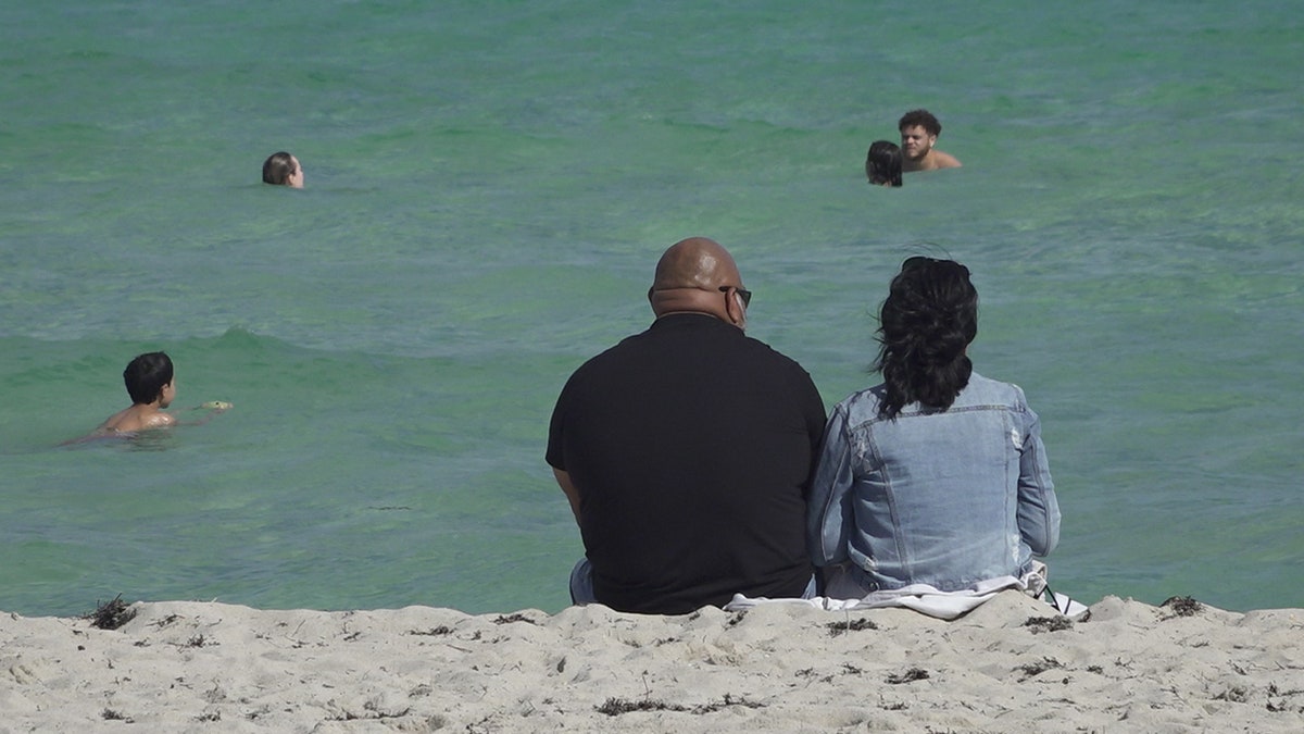 Couple sits on Miami Beach