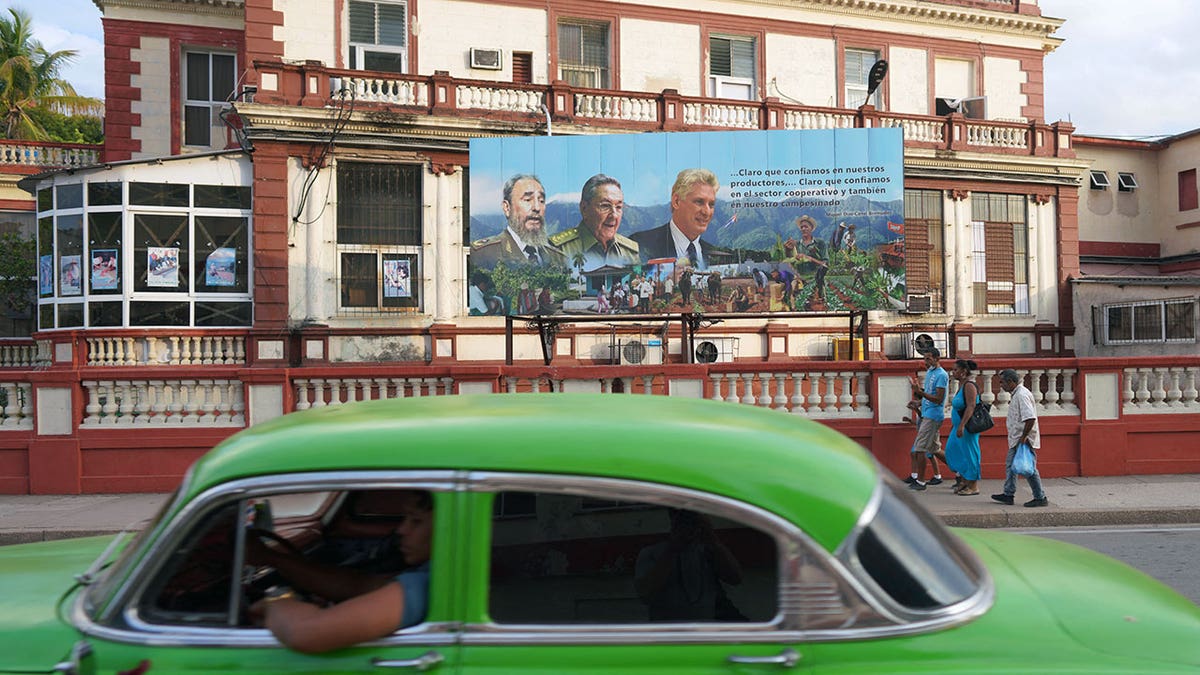 Images of Fidel Castro Raul Castro and Miguel Diaz-Canel displayed on a billboard in Havana