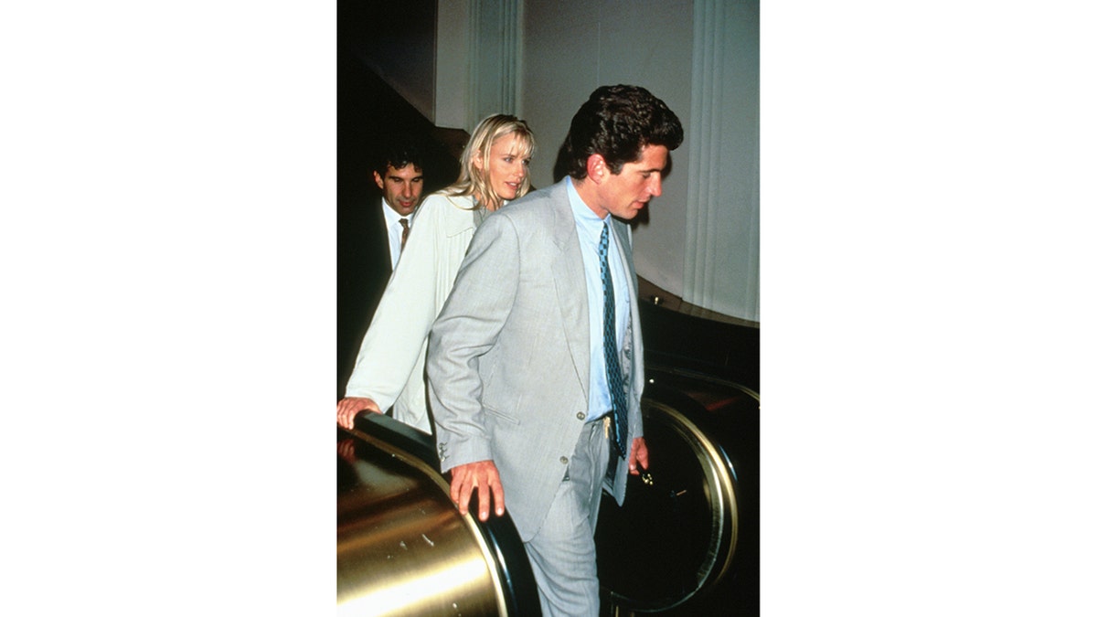 JFK Jr. and Daryl Hannah walking together.