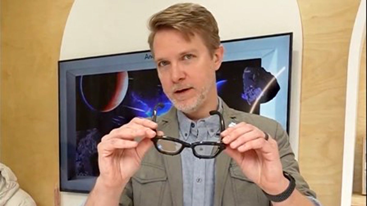 A man holding a pair of smart glasses