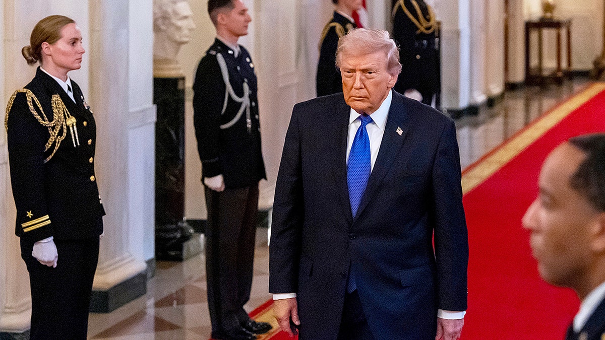President Trump walks into East Room of White House