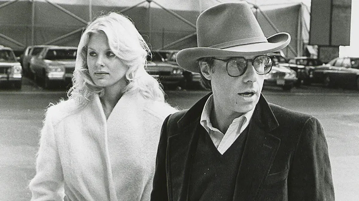 Dorothy Stratten and Peter Bogdanovich walking together.