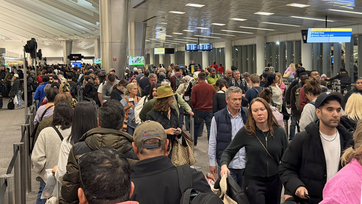 U.S. citizens and Green Card holders standing in a long line at Newark international airport immigration checkpoint