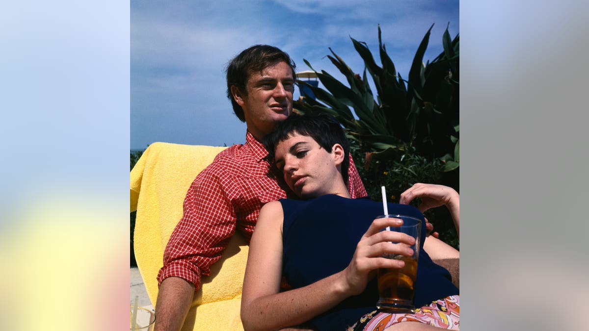 Liza Minnelli laying on Peter Allen