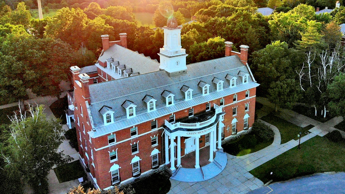 The exterior of a building at Green Mountain College is shown at sunset.