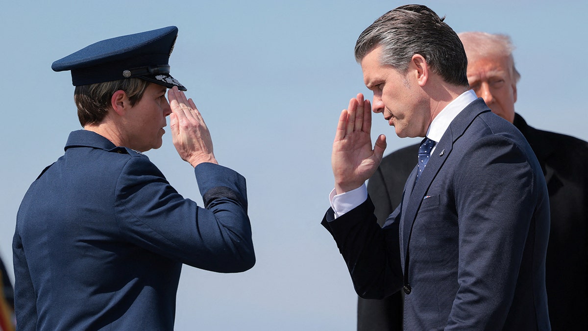 Secretary of War Pete Hegseth salutes at Dover Air Force Base