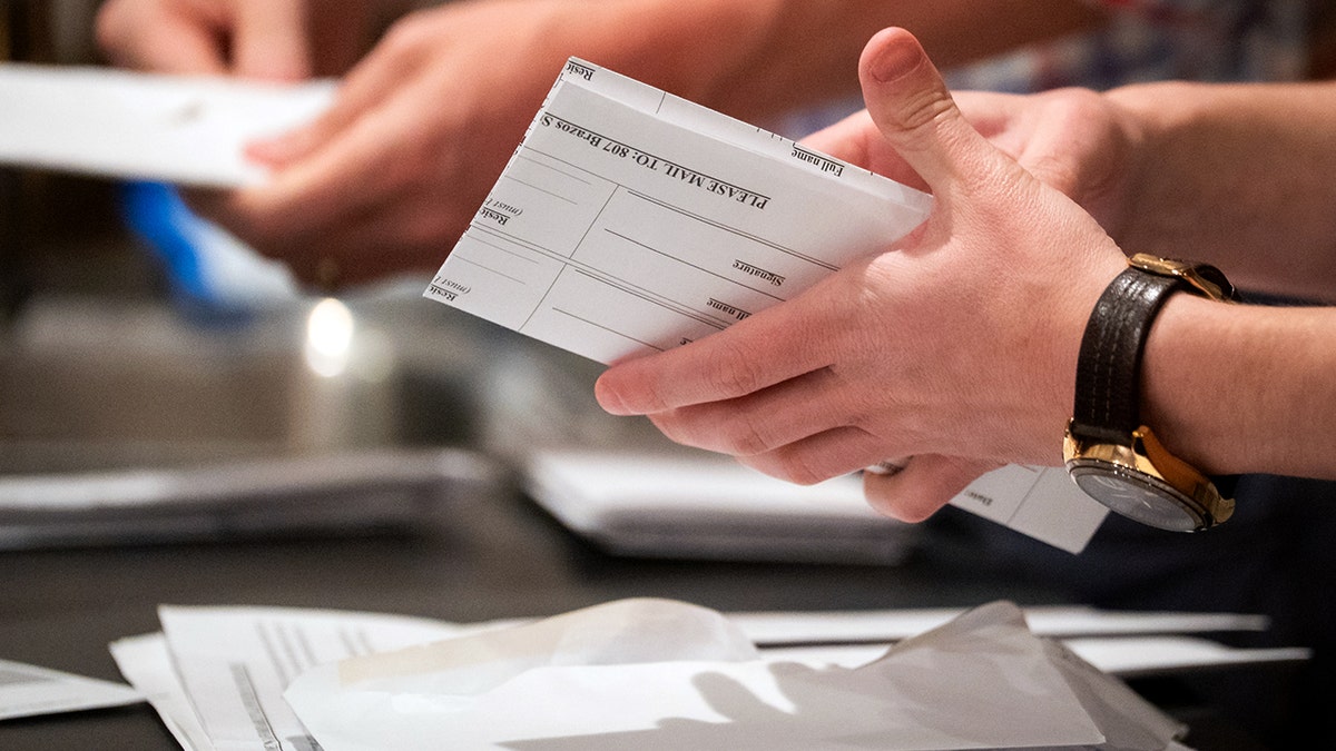 A person holds a folded document.