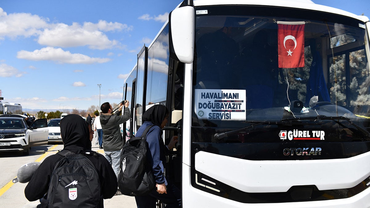 Iran's women's soccer players board a bus
