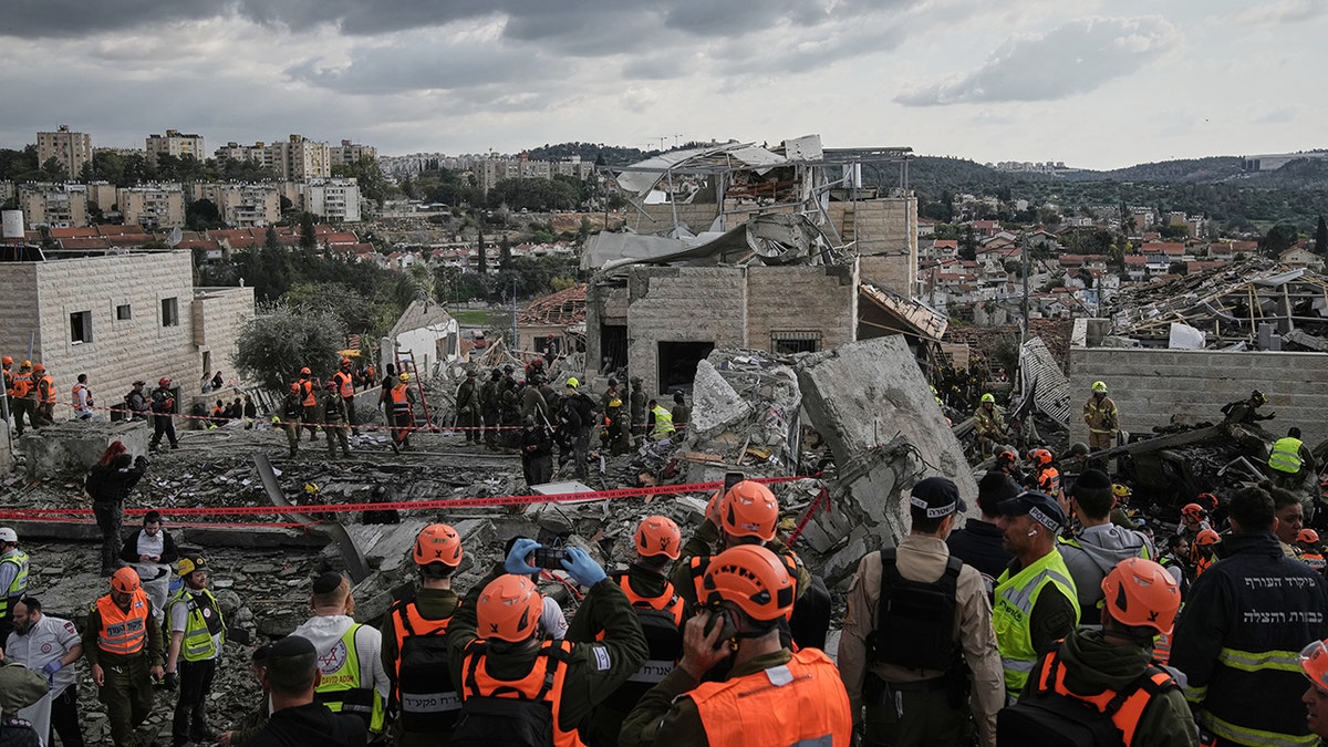 Rescue workers and military personnel working amidst the rubble of a destroyed building in Beit Shemesh.
