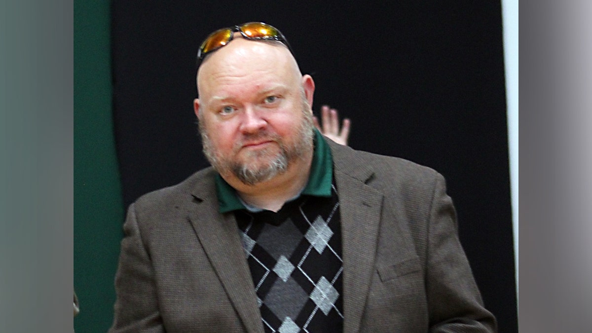 Former principal Jeremy P. Williams looks at the camera.