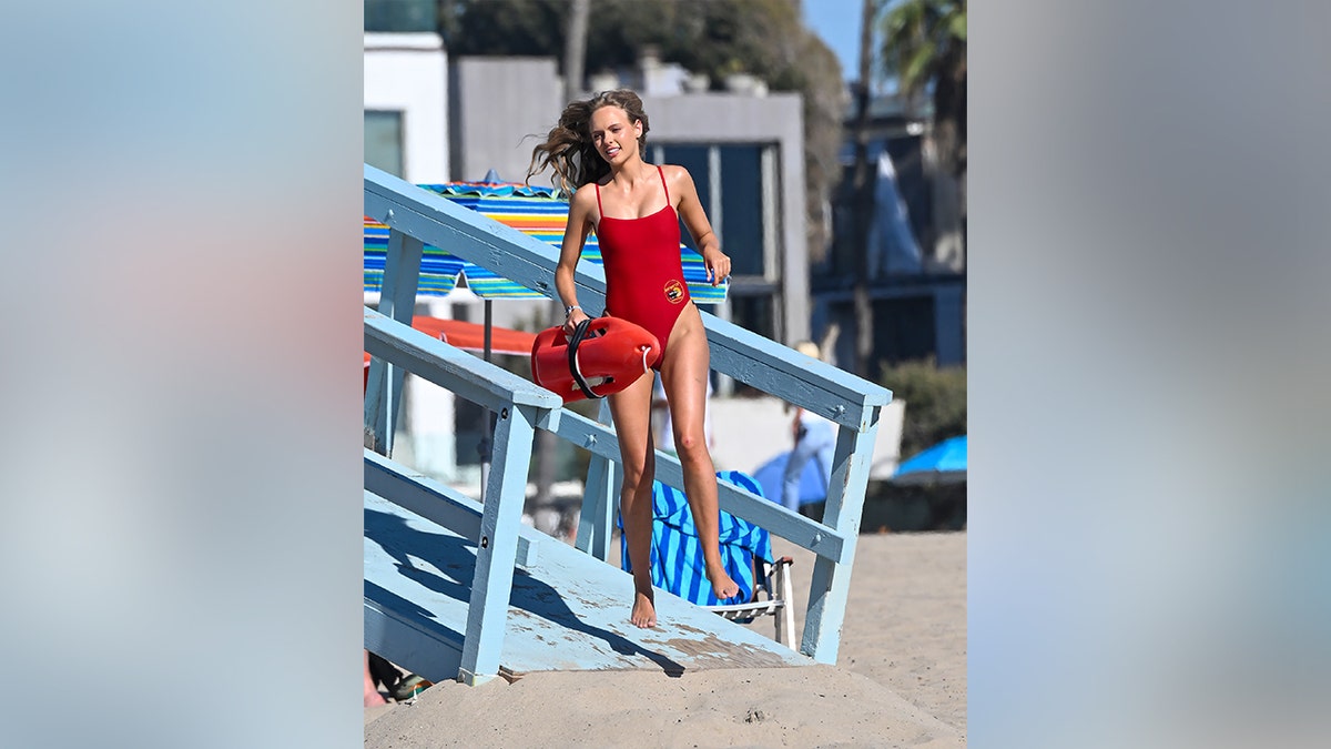 Hessie Harrison jumping over a surfboard again while filming the reboot.