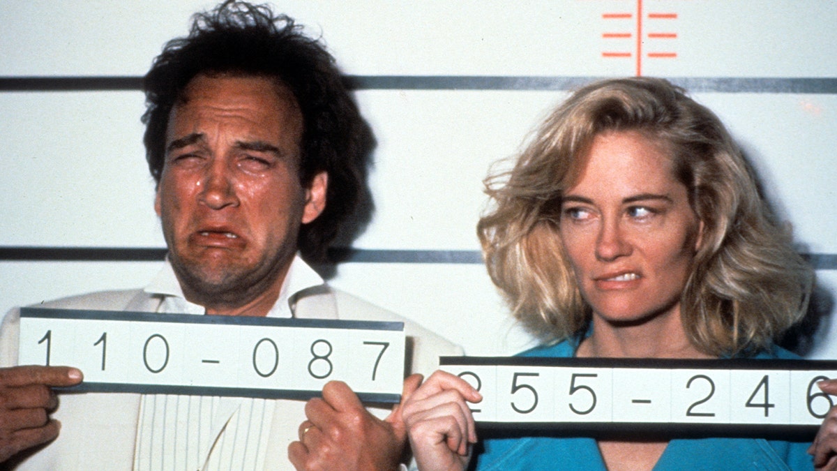 Jim Belushi poses with Cybil Shepherd