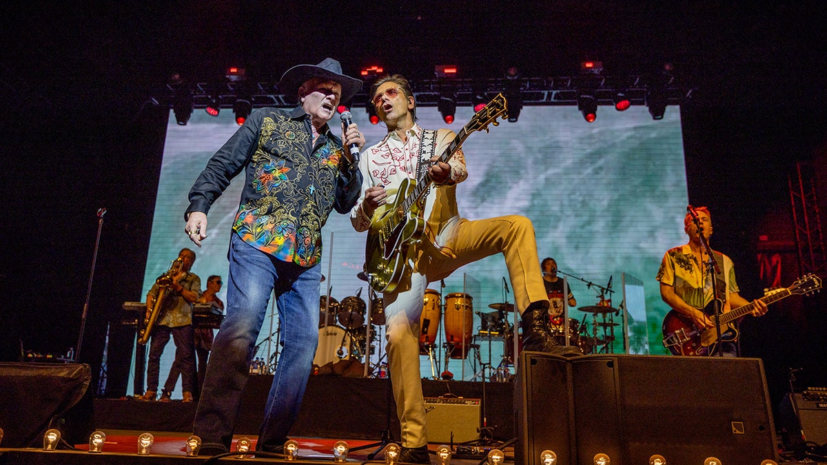 John Stamos playing with Mike Love of the Beach Boys