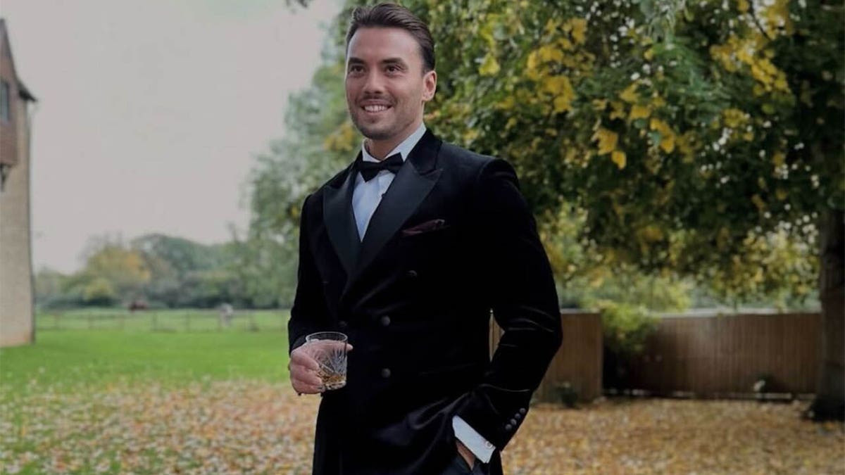 Jordan Wright standing outside in a tuxedo