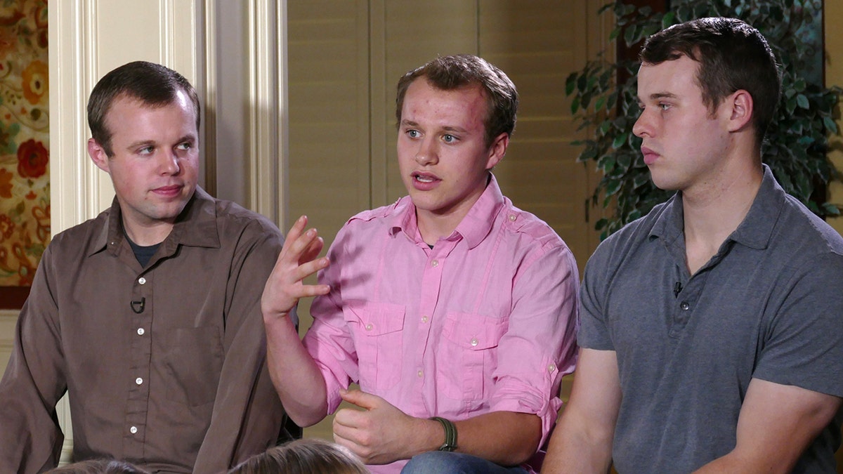 The Duggar brothers sitting together.