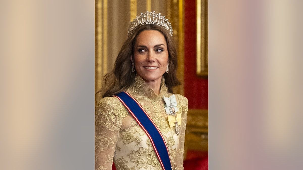 A close-up of Kate Middleton wearing a gold dress and tiara.