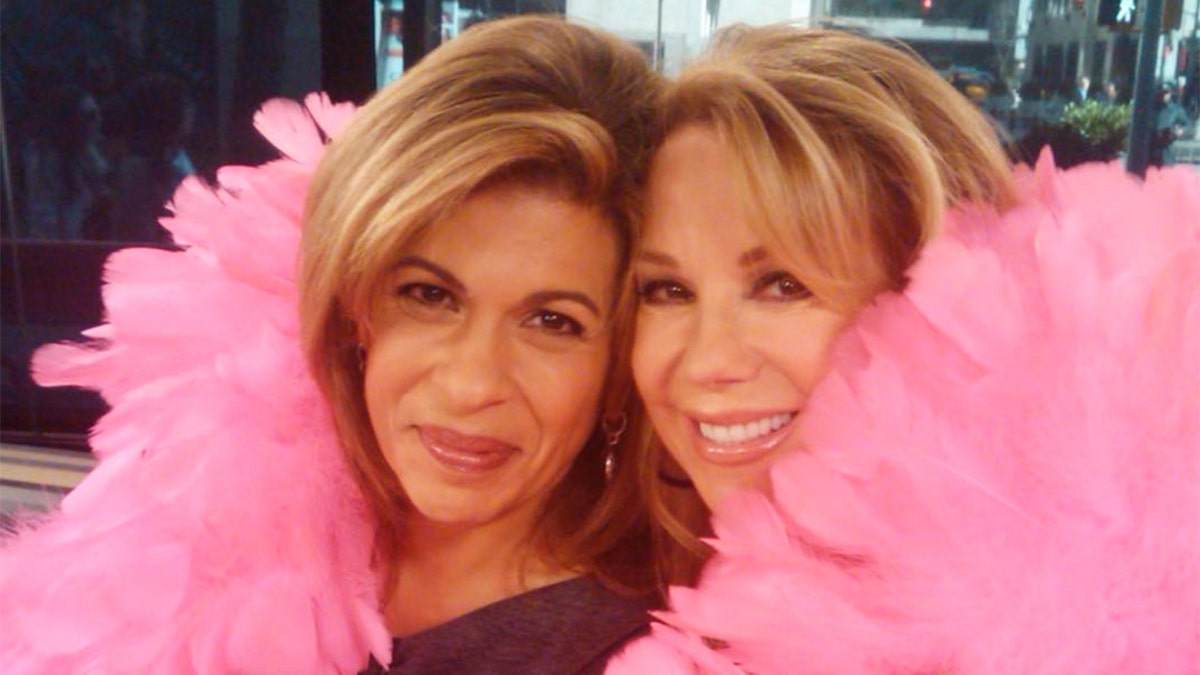Kathie Lee Gifford and Hoda Kotb in a giant pink boa.