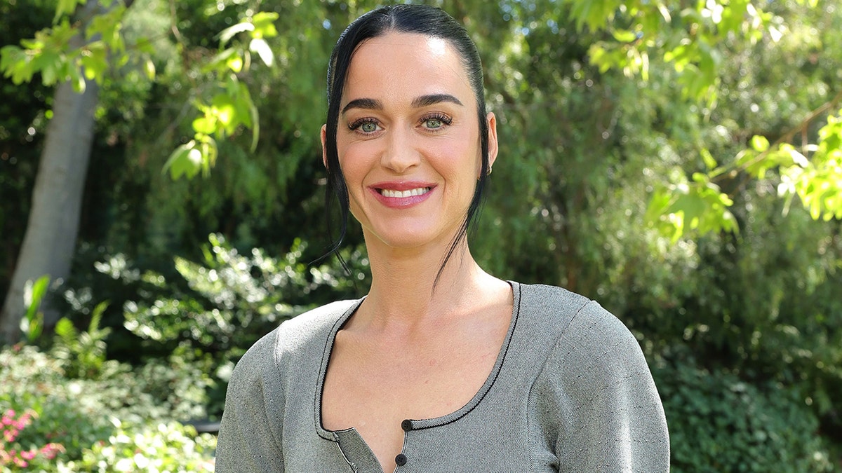 Katy Perry wearing a gray sweater at the Academy Awards Luncheon in Beverly Hills