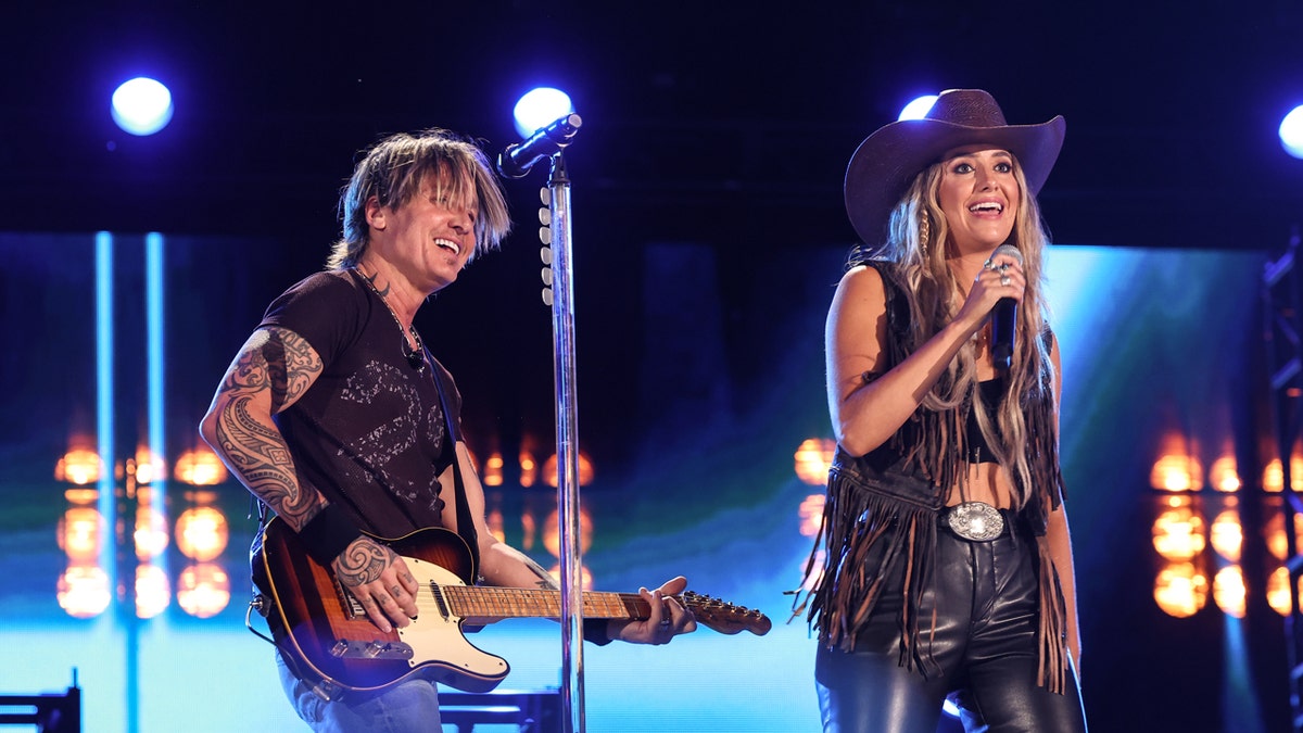 Keith Urban and Lainey Wilson performing onstage at the 2024 CMA Music festival.