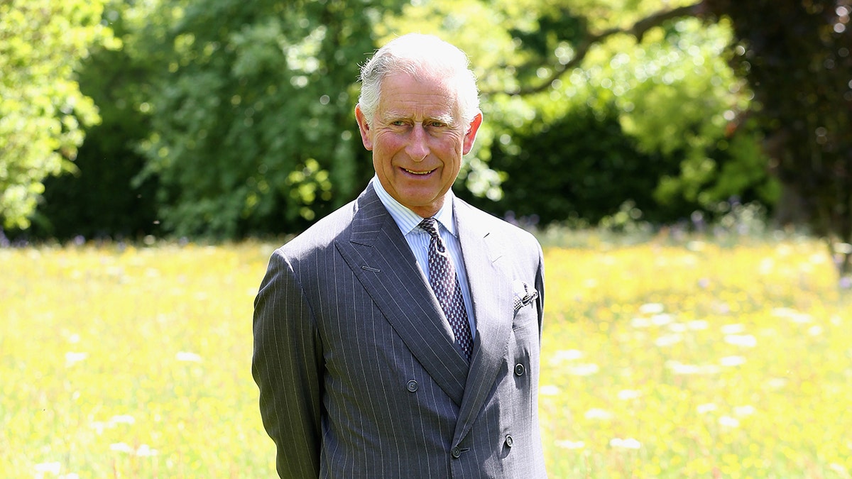 King Charles smiling in the fields of Highgrove.