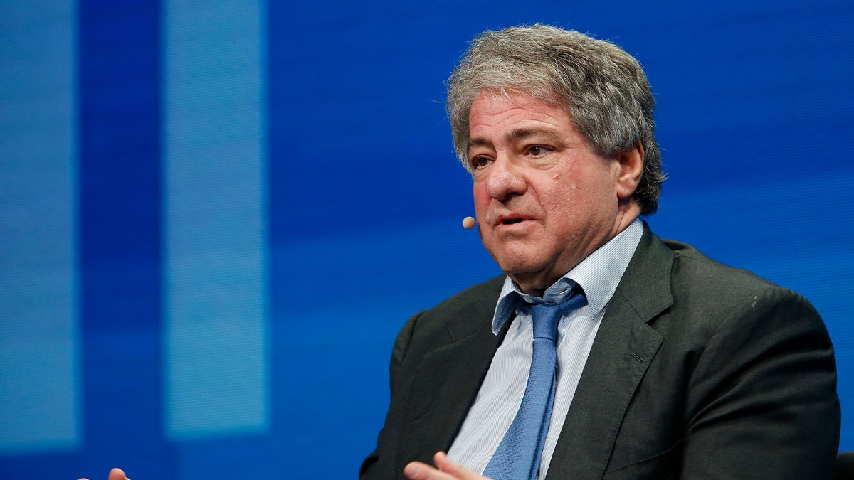 leon zwart draagt pak dat spreekt tijdens het evenement