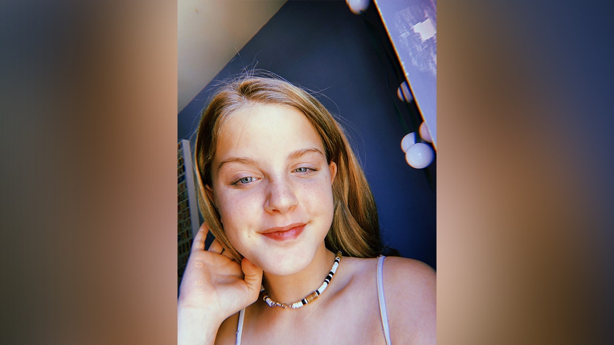 Lilly bova with tank top and white and brown necklace