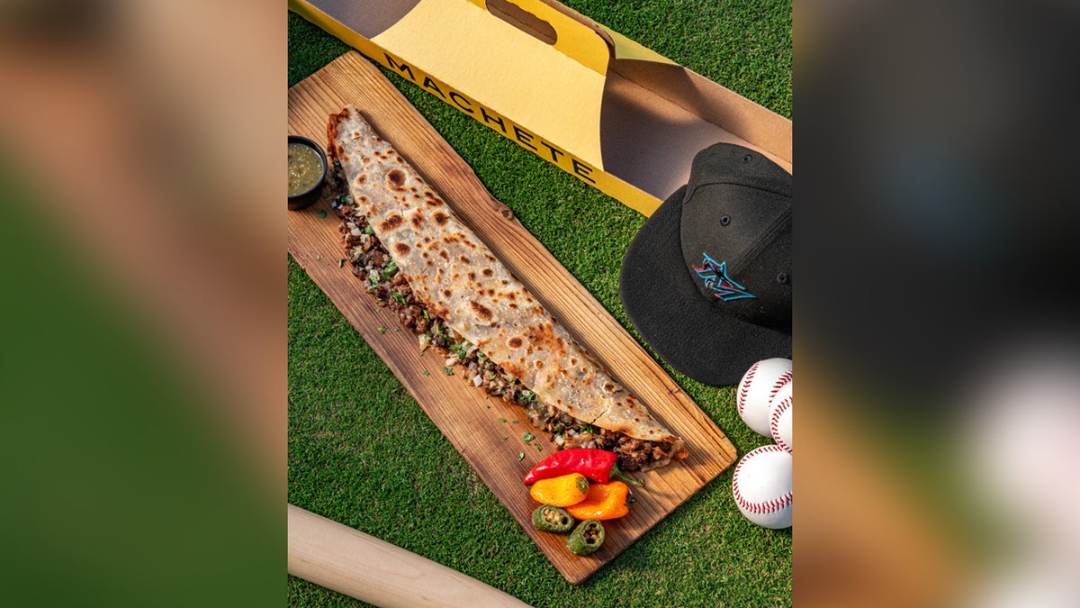 Two-foot homemade flour tortilla griddled on the flat top with melted mozzarella and Oaxaca cheeses, house-marinated carne asada, smoky guajillo pepper sauce, salsa verde and cilantro. Served in a custom carrying case.