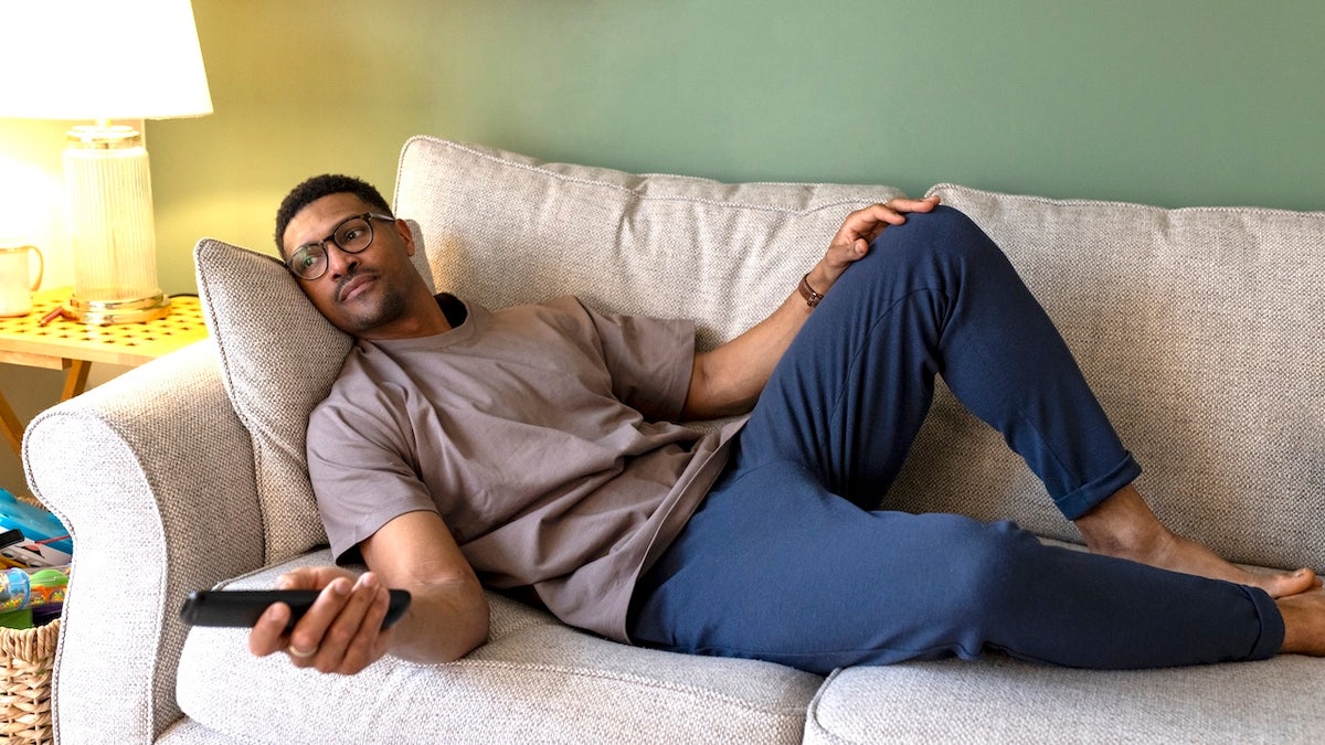 Man watching TV on couch