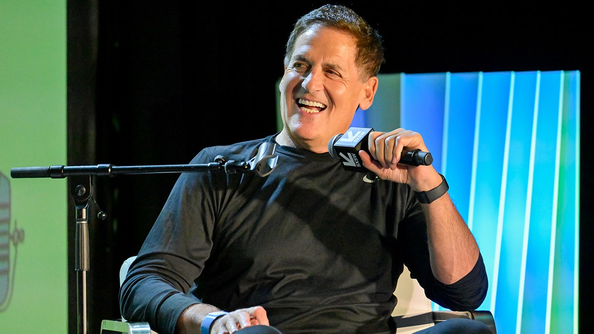Mark Cuban at Robin Arzón Live with Mark Cuban during the SXSW Conference & Festivals held at the Hilton Austin Downtown on March 14, 2026 in Austin, Texas. Seen holding mic on stage and smiling.