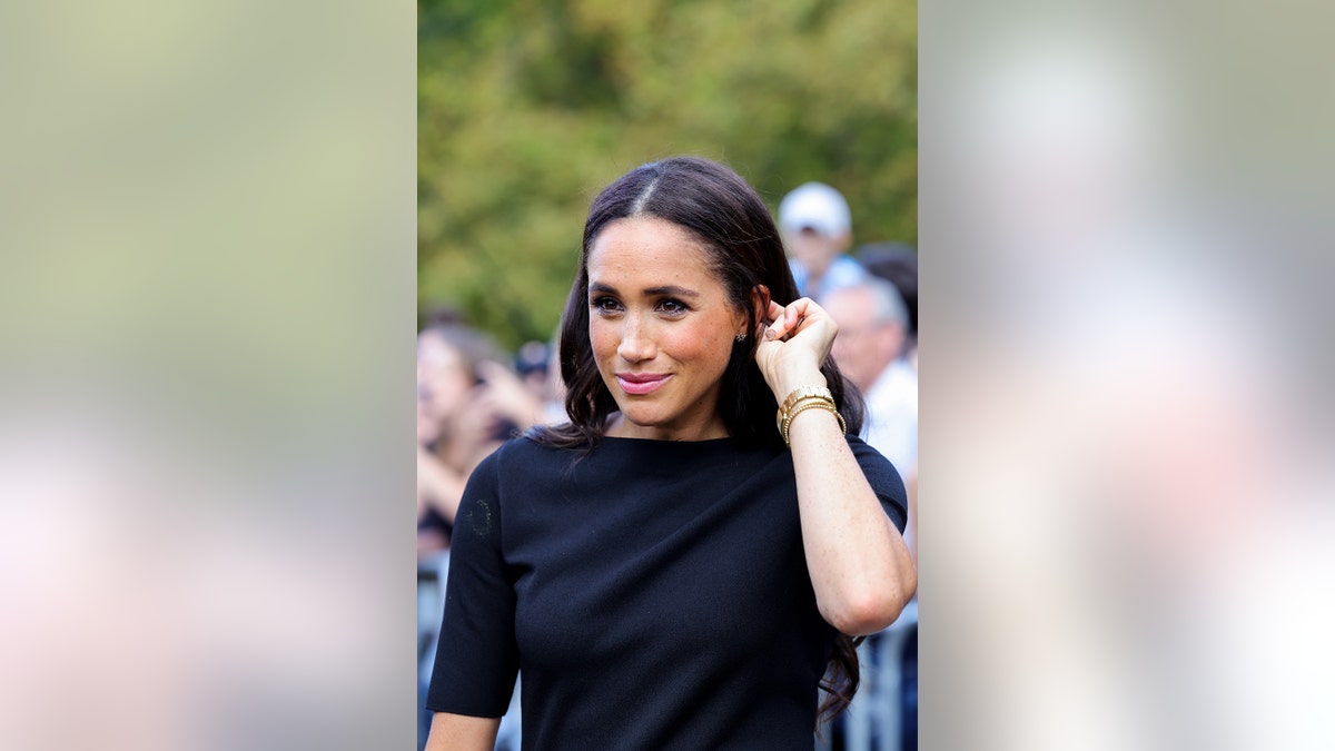 A close-up of Meghan Markle wearing black.