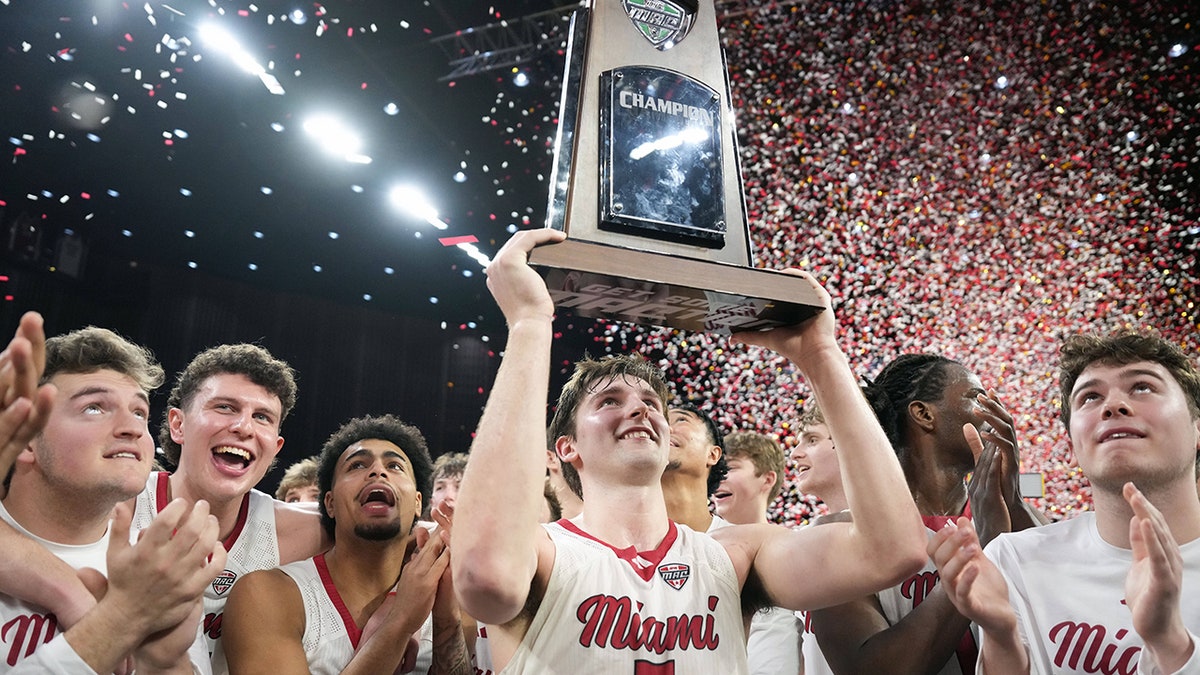 Peter Suder raises the trophy