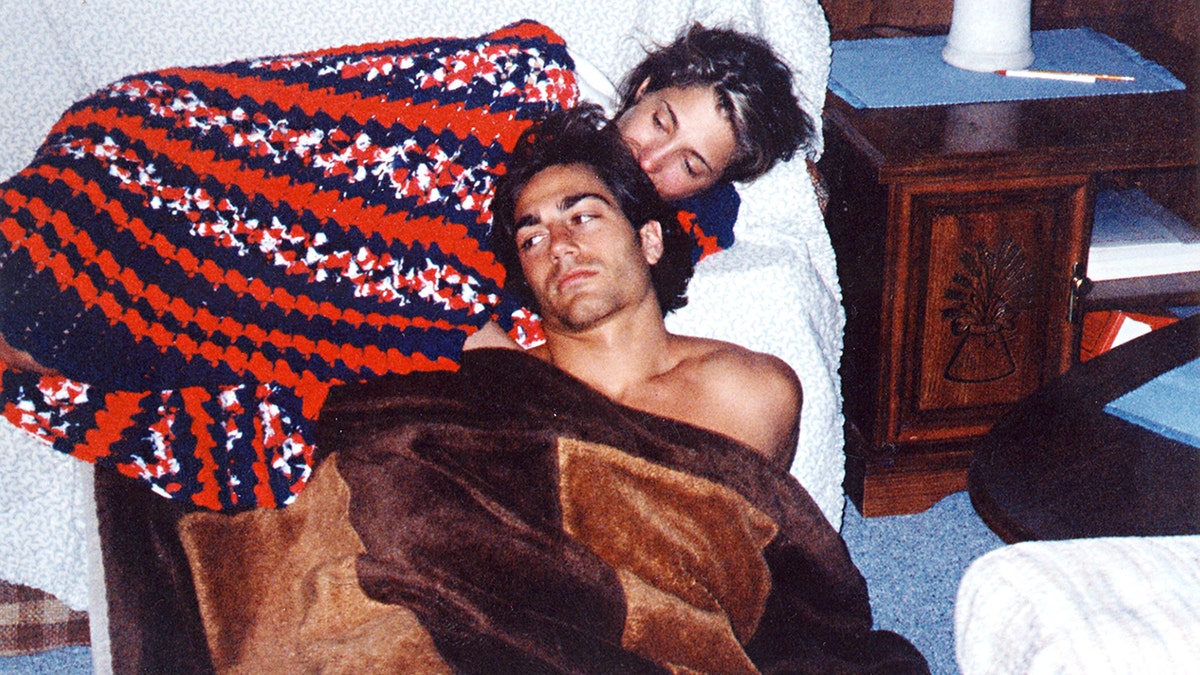 Carolyn Bessette and Michael Bergin wrapped up in blankets in the basement of his parent's home.