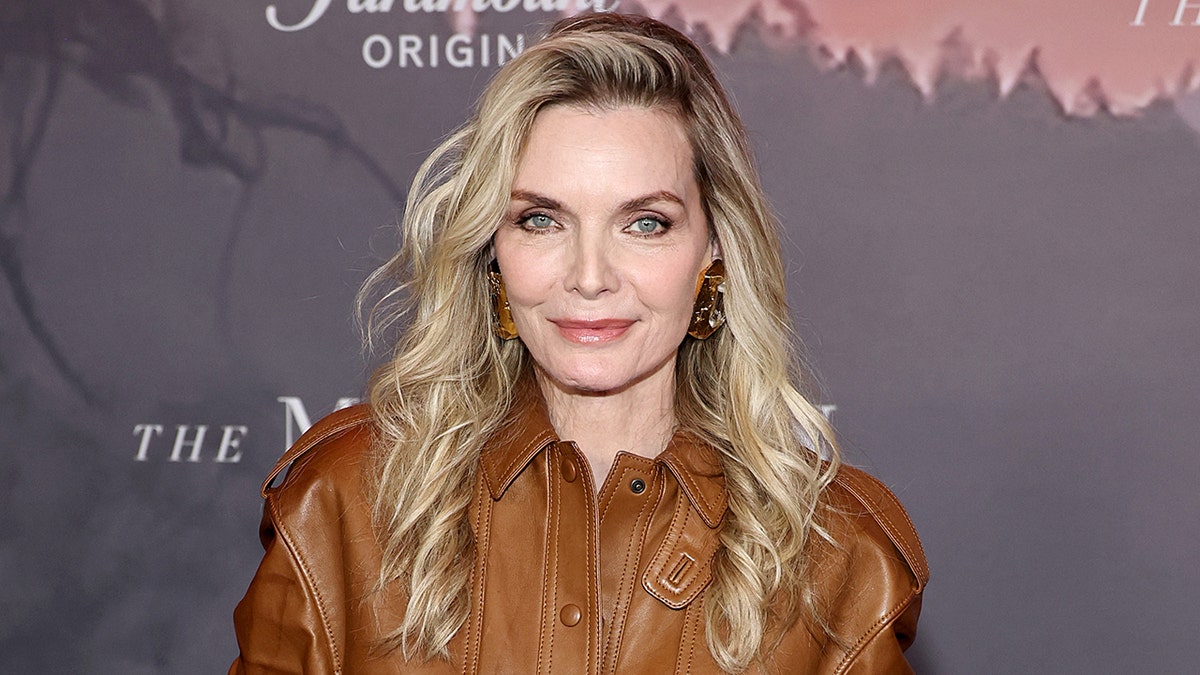Michelle Pfeiffer poses on the red carpet at the premiere of The Madison in New York City.