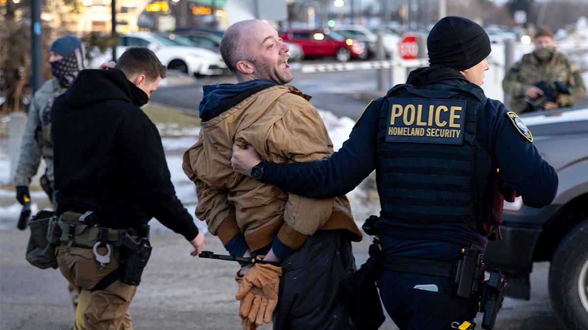 Federal agents arrest protester outside ICE facility in Minneapolis.