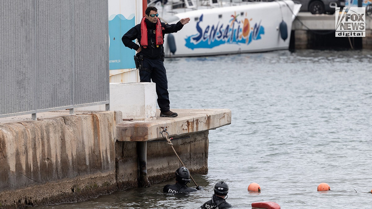 Catalan police divers searching for Alabama student James Gracey in the water near the shoreline and marina.