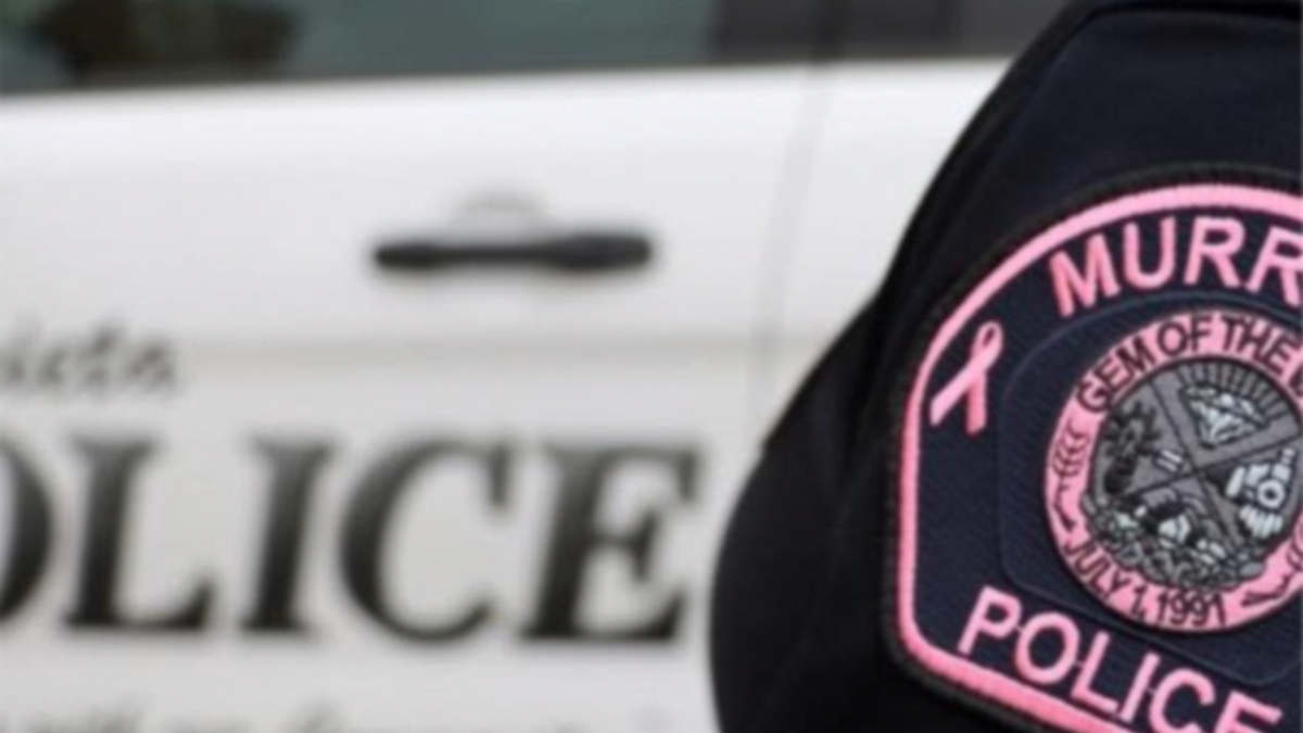 Murrieta Police Department patch on uniform with patrol vehicle