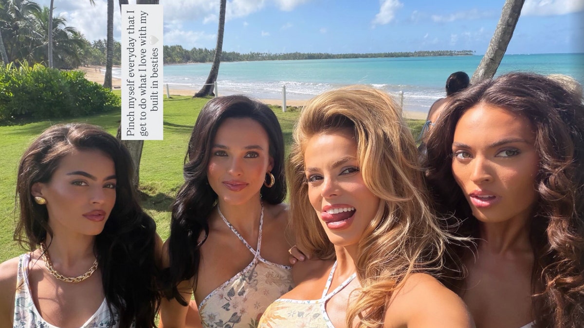 The Nader sisters pose together on the beach for a selfie.