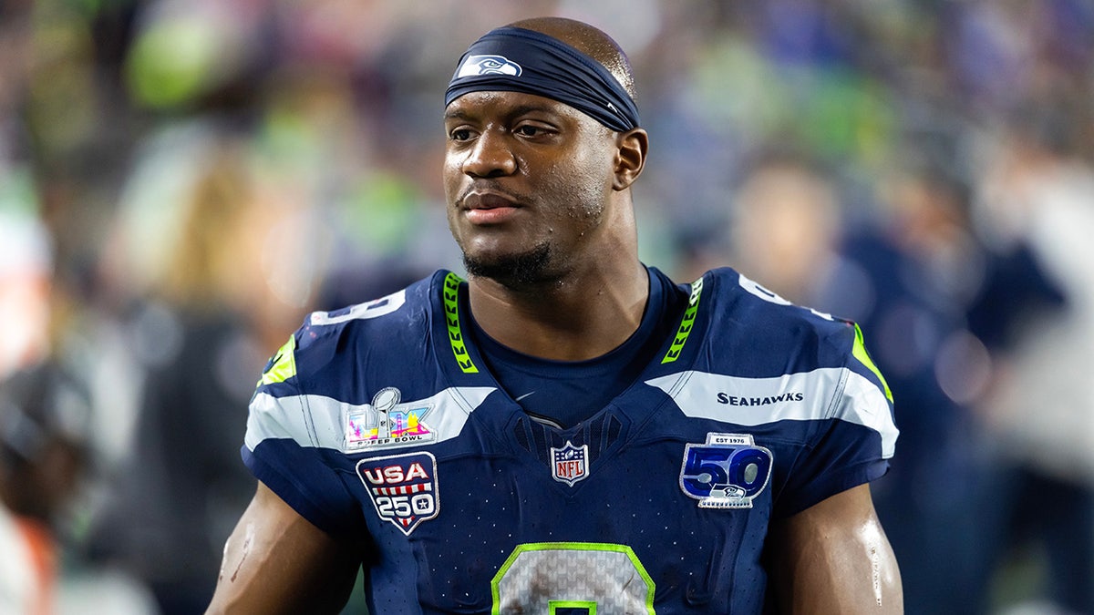 Kenneth Walker looks on