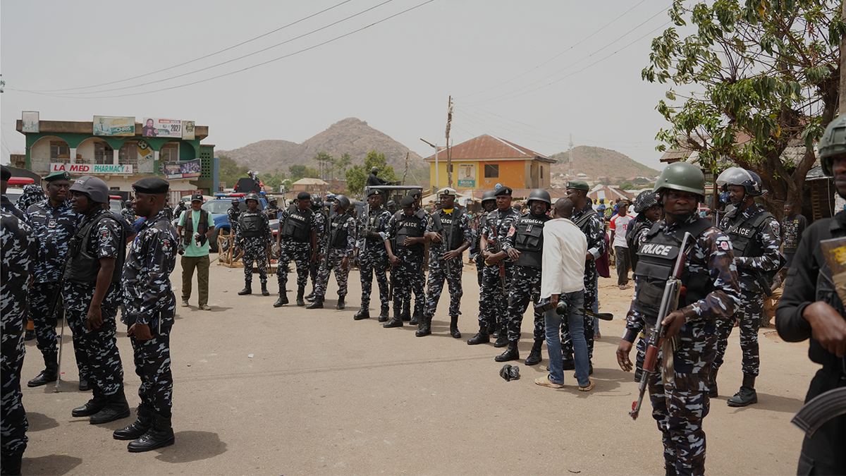 Police officers gather at the scene of Sunday night gunmen attack in Gari Ya Waye community in the Jos North Nigeria, Monday, March 30, 2026.