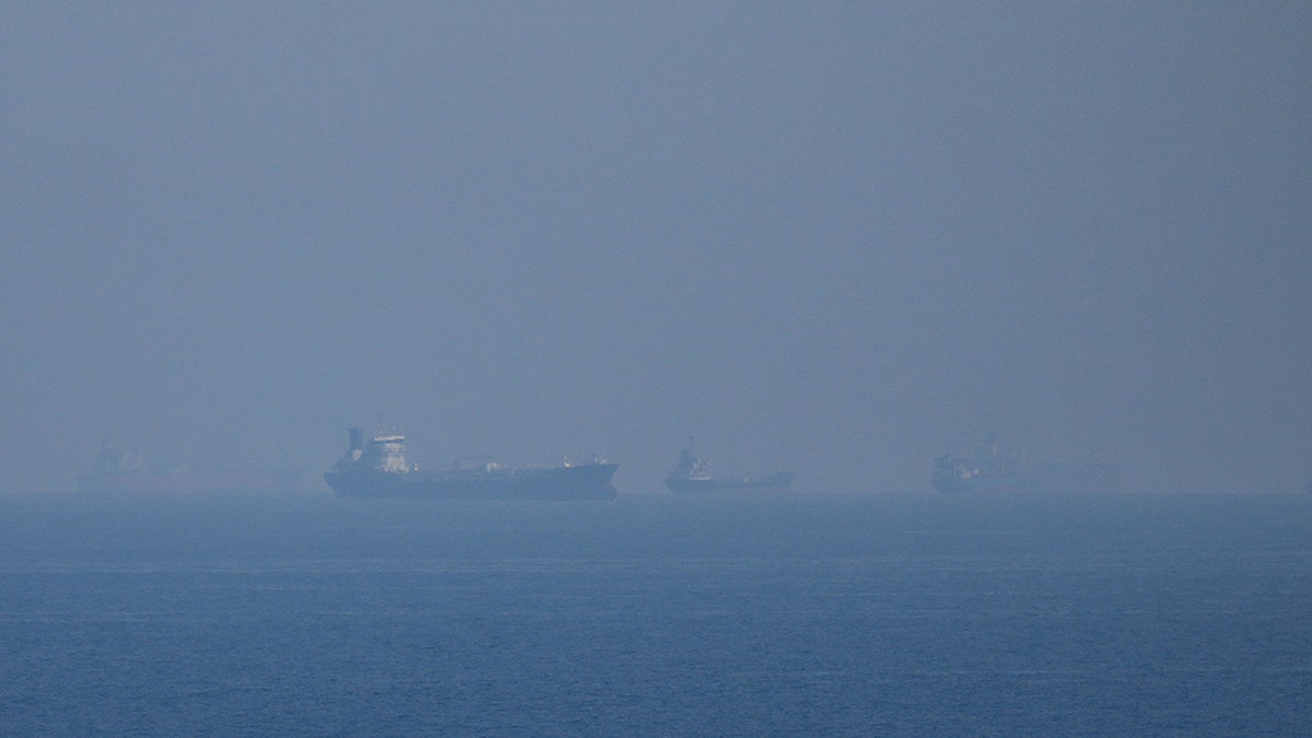 Oil tankers and cargo ships lined up in the Strait of Hormuz.