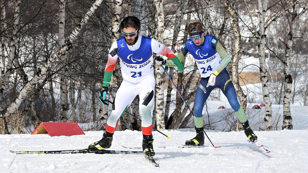 Iran's Aboulfazl Khatibi Mianaei and Ukraine's Serafym Drahun skiing in para cross-country event