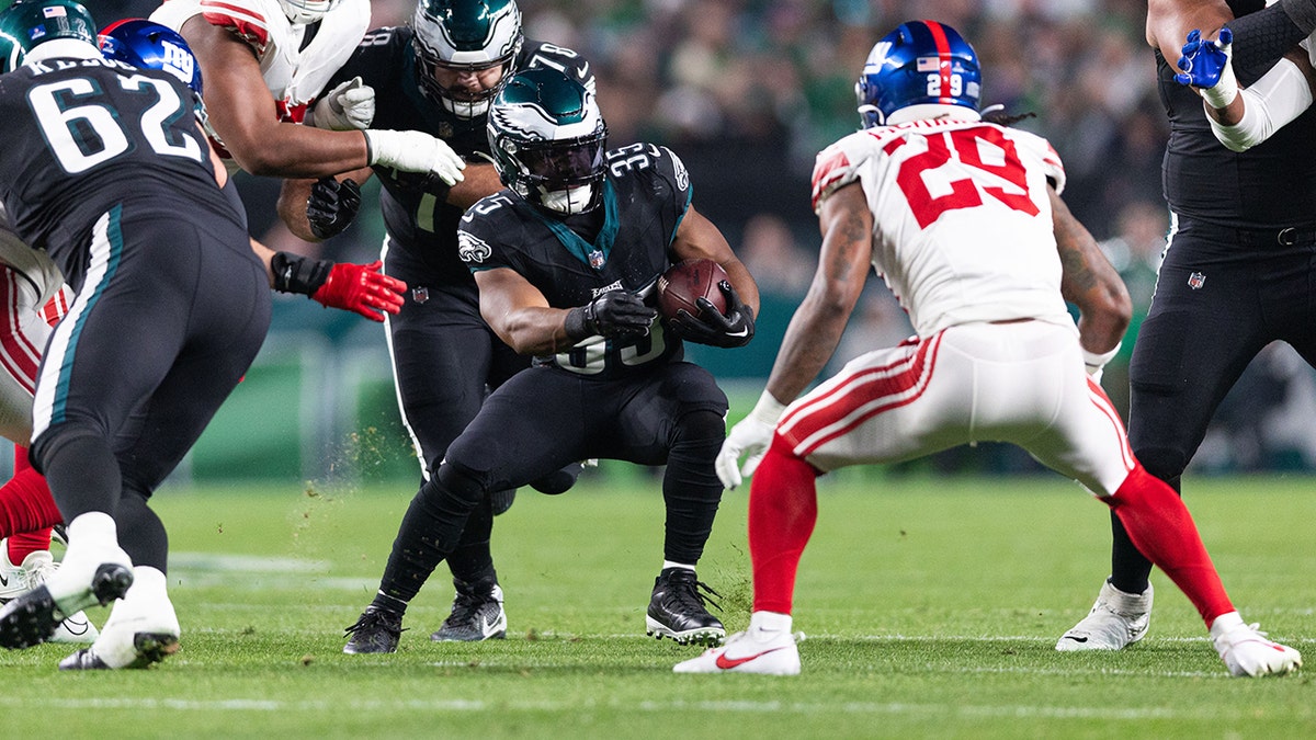 Boston Scott carrega a bola durante um jogo